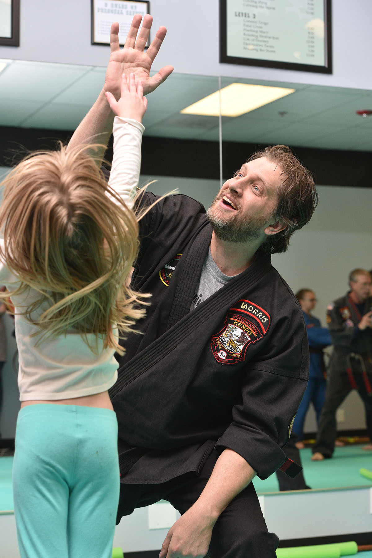 Instructor high-fiving student