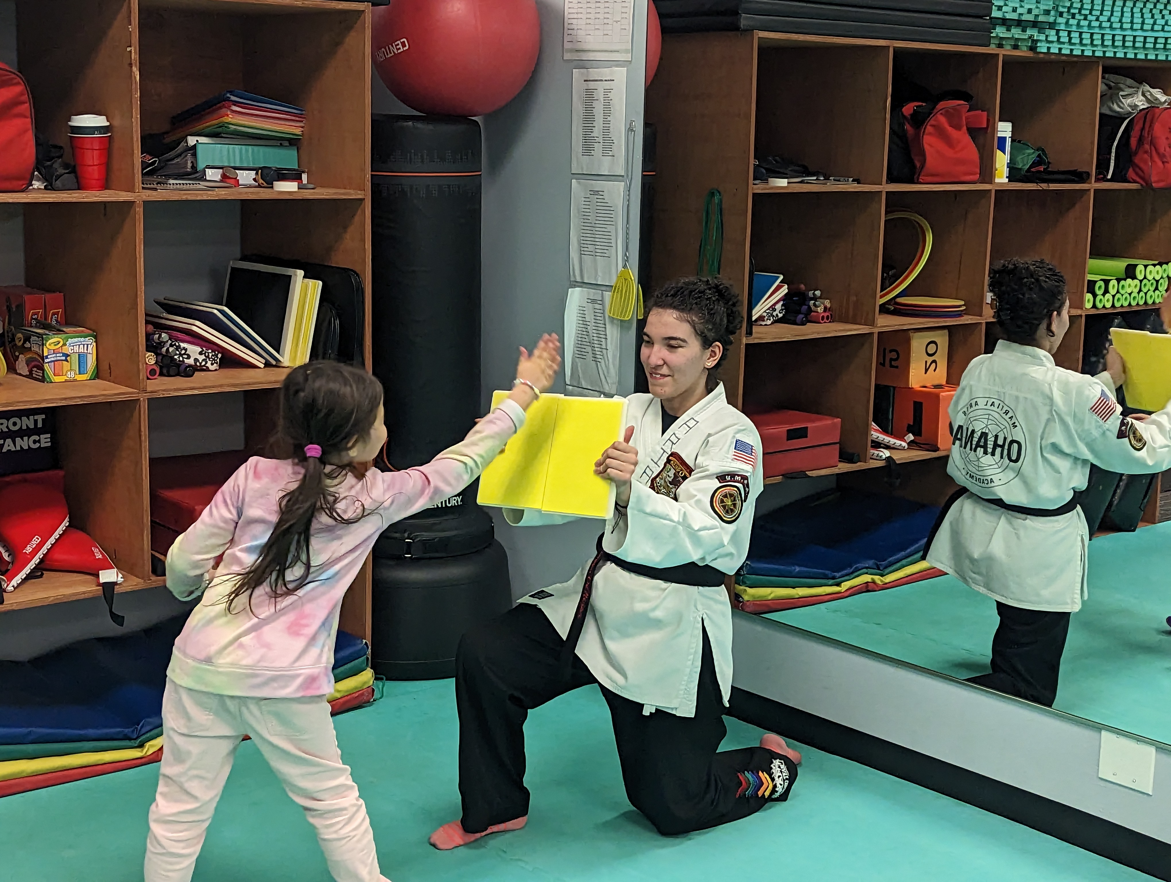 Young Tigers student practicing a strike on a training board
