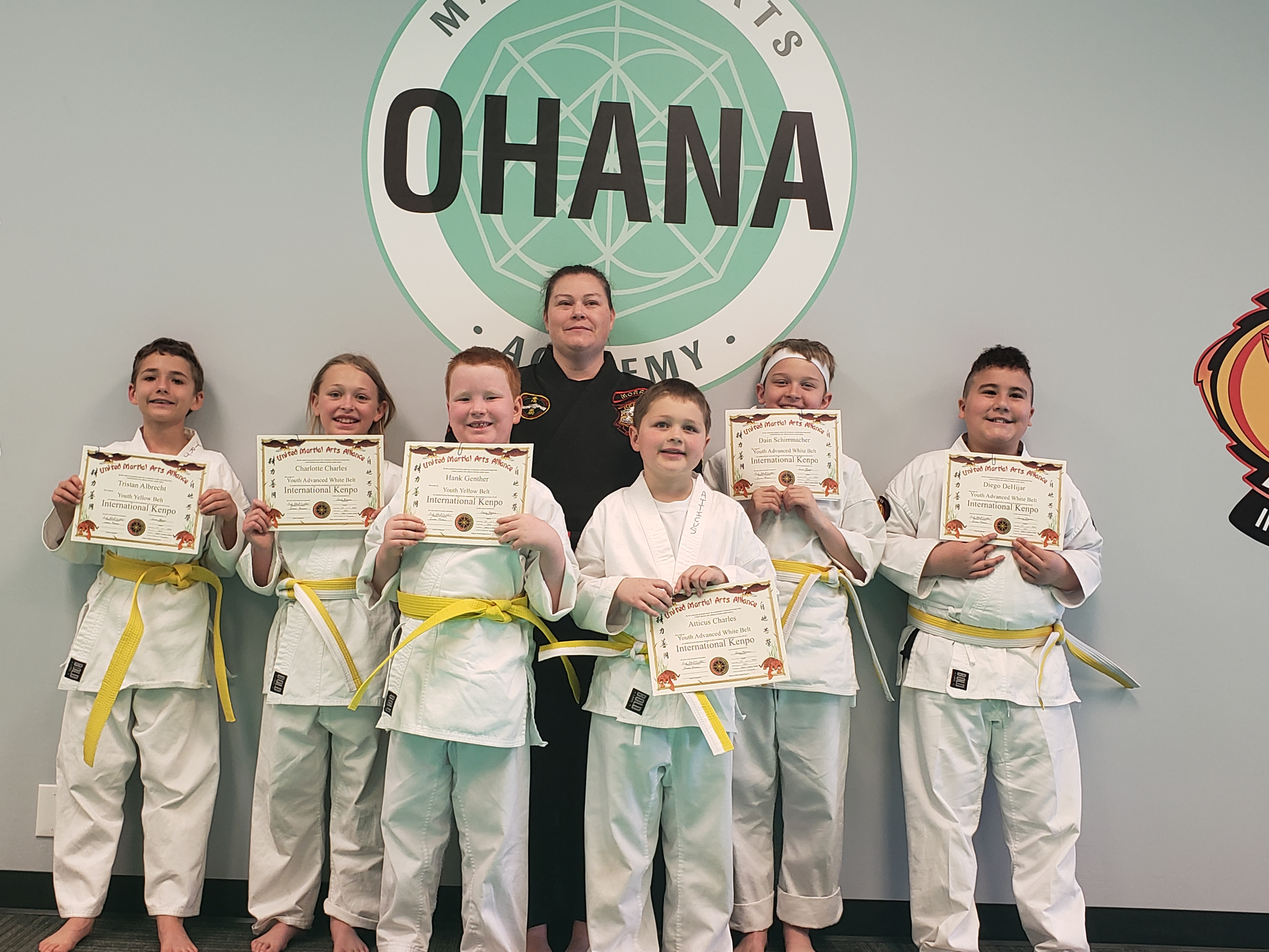 Group of youth students with certificates and Sensei Carissa